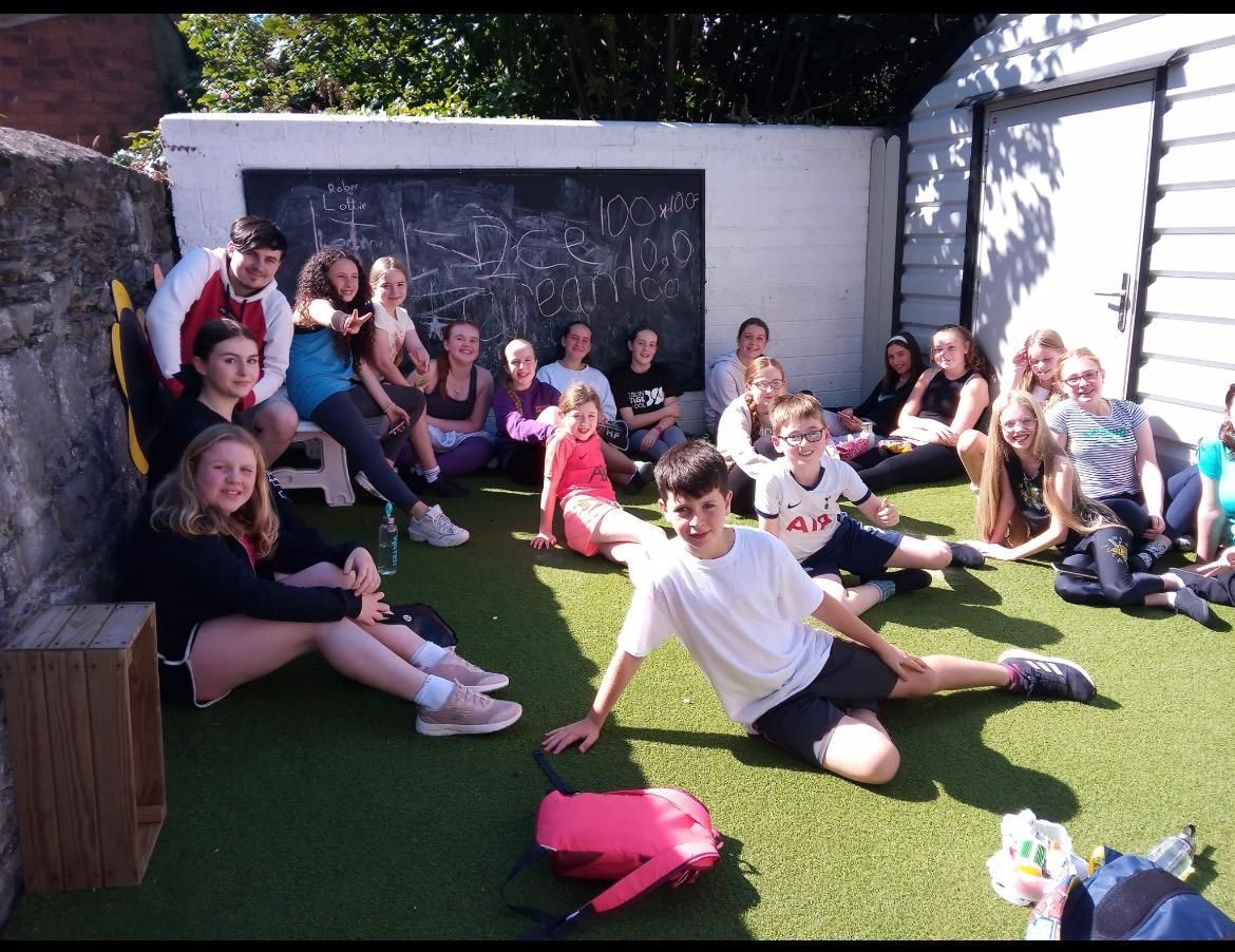 A woman with long hair is smiling in a black and white photo.