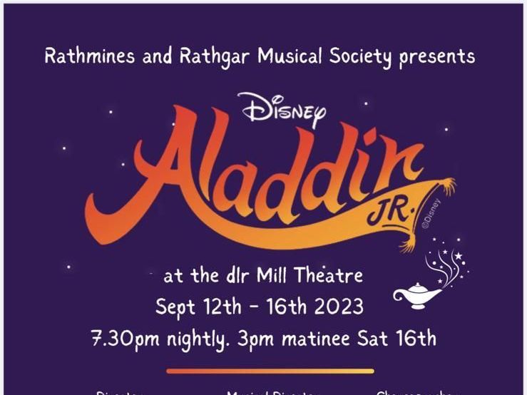 A group of people are standing on a stage in front of a crowd.