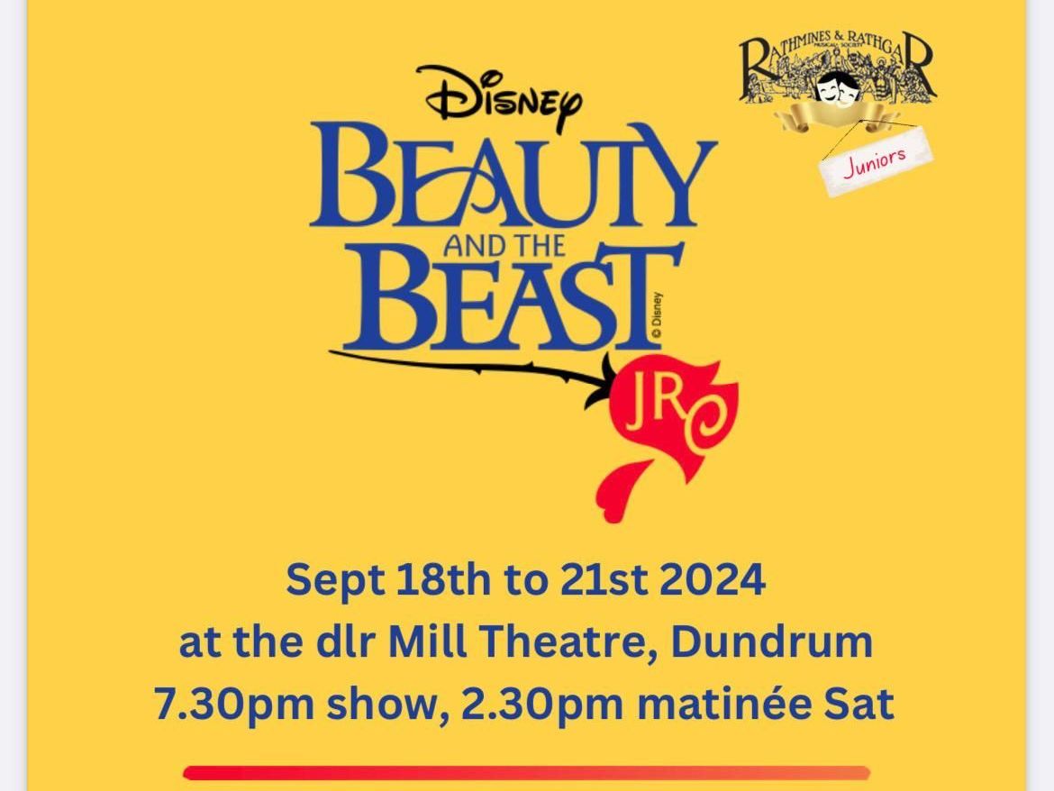 A large group of people are dancing on a stage in front of an orchestra.