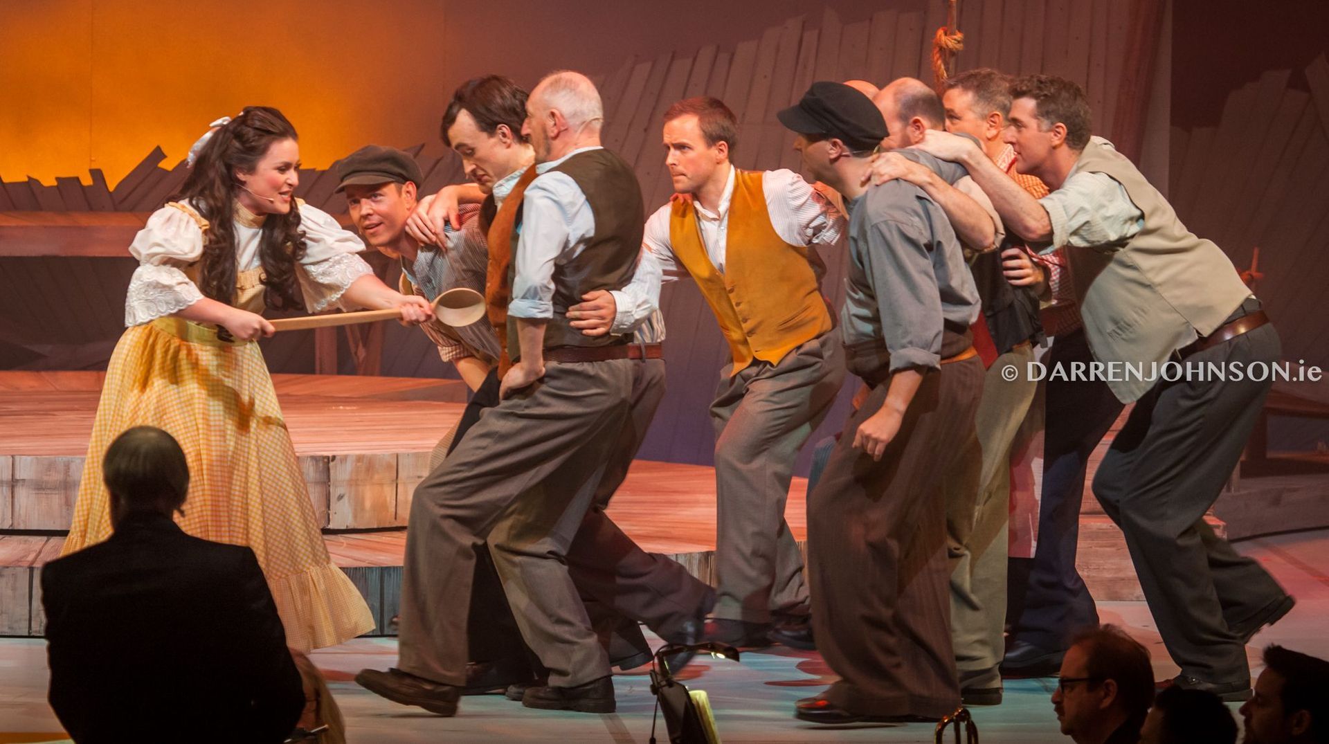 A group of people are dancing on a stage.