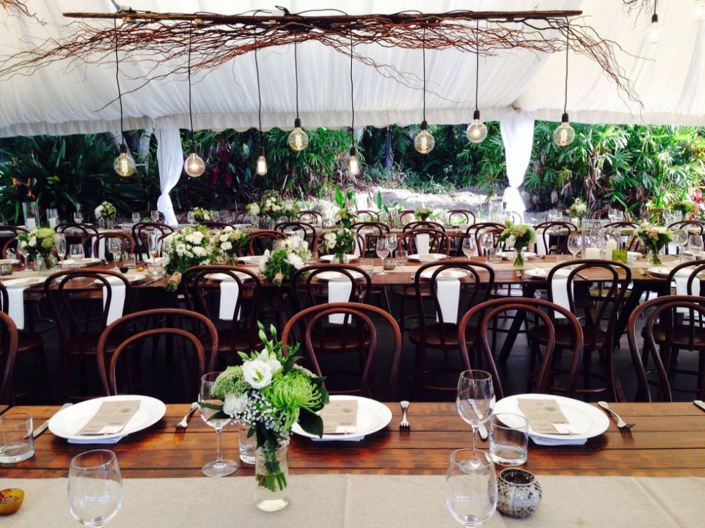 Wooden Wedding Table And Chairs With Flowers And Pendant Lights — Wedding & Event Hire In Goonellabah, NSW