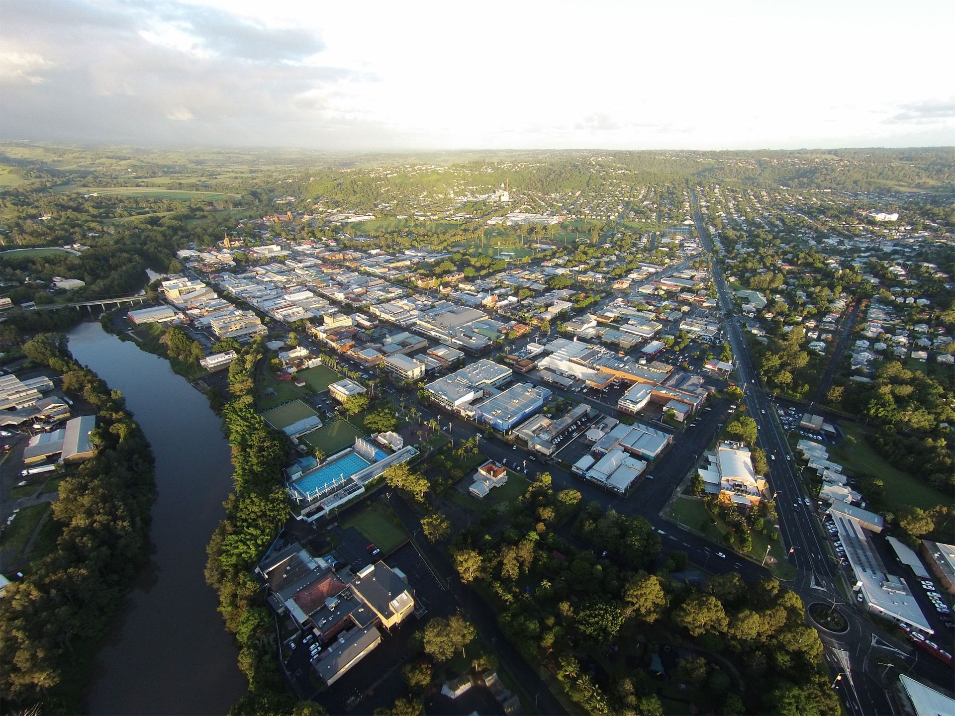 An Aerial View Of A City Surrounded By Trees And A River — Wedding & Event Hire In Lismore, NSW