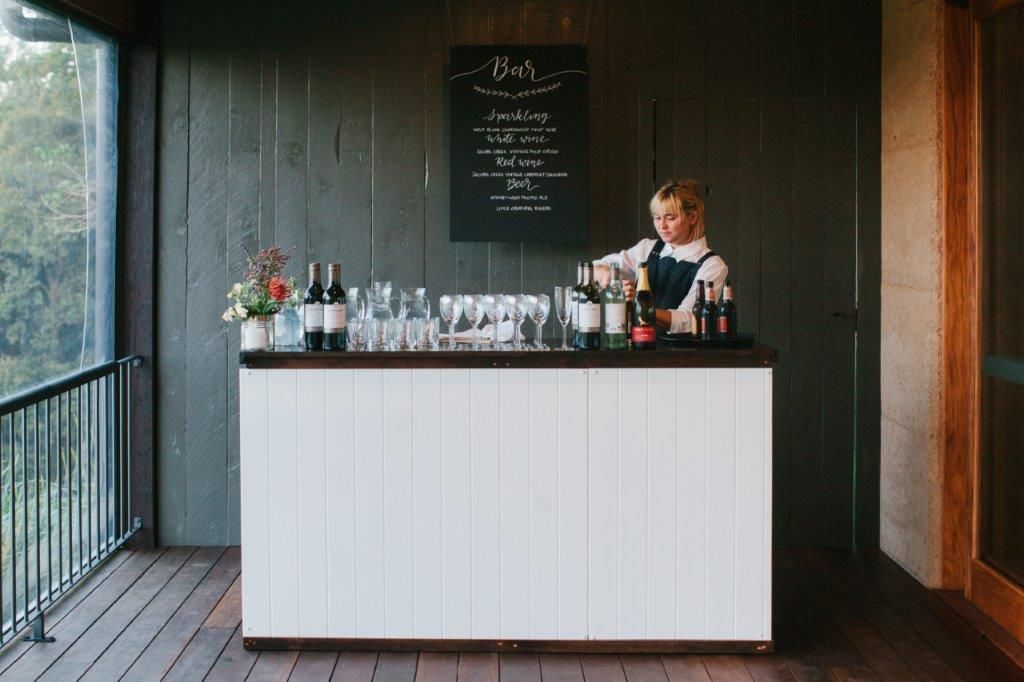 A Bartender Is Preparing A Drink At A Bar On A Balcony — Wedding & Event Hire In Byron Bay, NSW