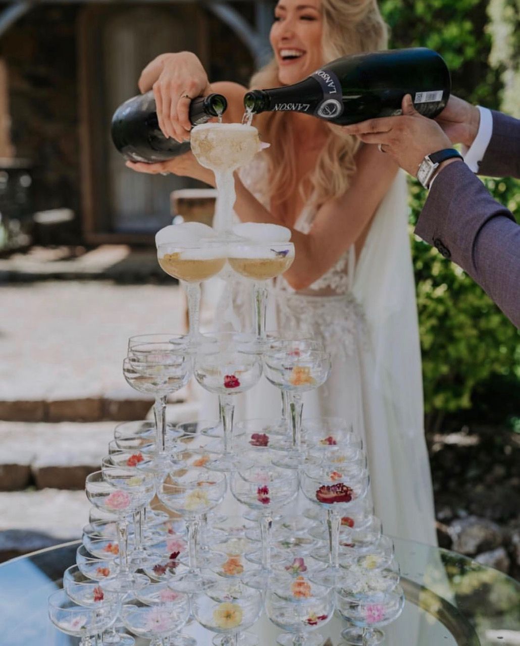 A Bride Is Pouring Champagne Into A Pyramid Of Champagne Glasses — Wedding & Event Hire In Byron Bay, NSW