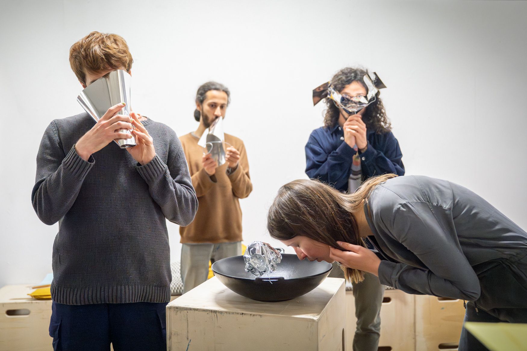 Four people singing into the resonant artifacts