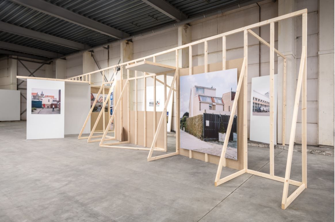 Life-size wooden structure that resembles D.I.Y. trestles with pictures on them