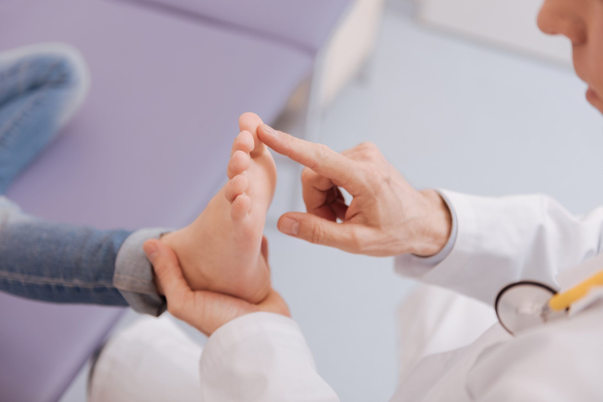 A doctor is examining a child 's foot.