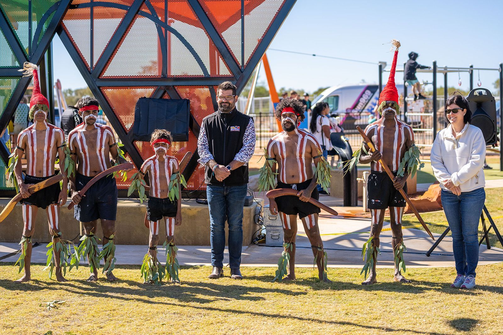 A group of people are standing next to each other in a field.