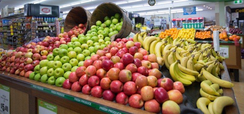 A display of apples and bananas in a grocery store.