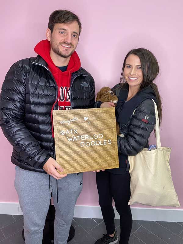 A man and a woman are holding a sign that says waterloo goggles.
