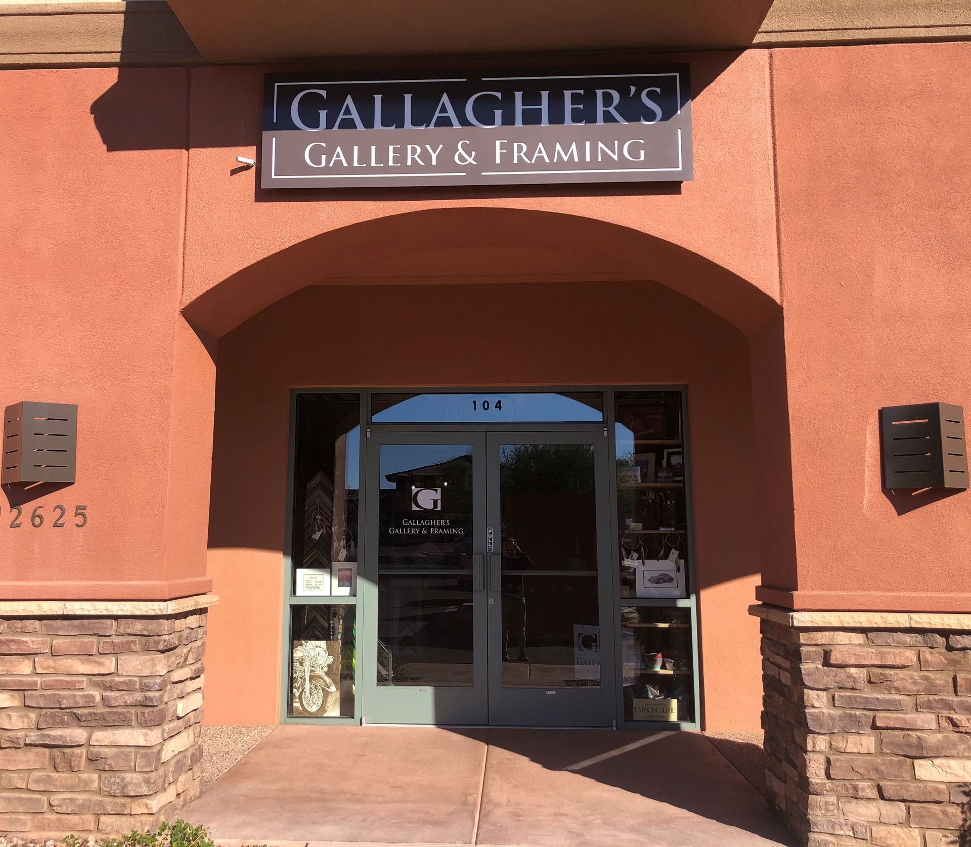 Gallagher's Gallery & Framing shop front with an arched entrance, glass doors, and a sign.
