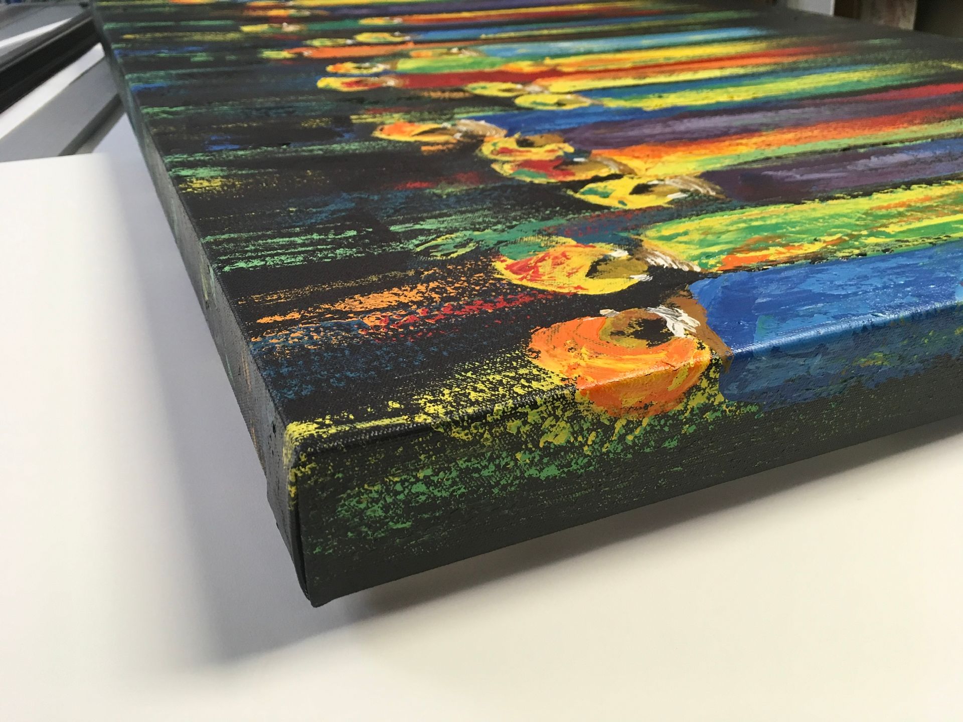 Two-story house with gray siding and garage doors, wet street reflects the evening sky.