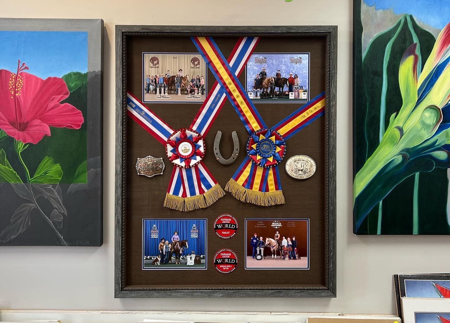 Two-story house with gray siding and garage doors, wet street reflects the evening sky.