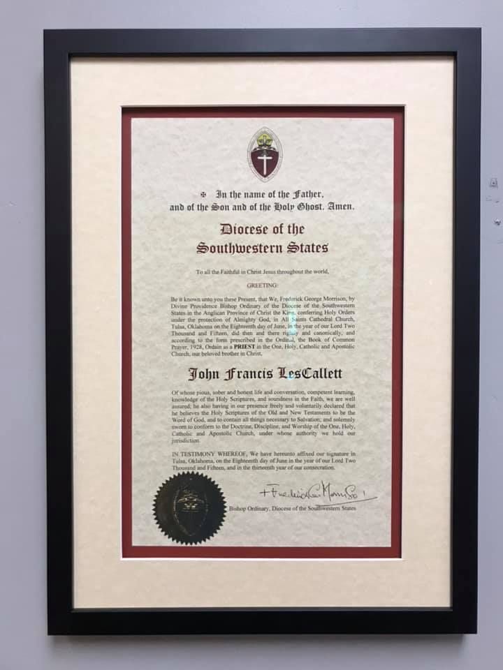 Framed document with black frame, red and cream mats. Includes text and a seal.