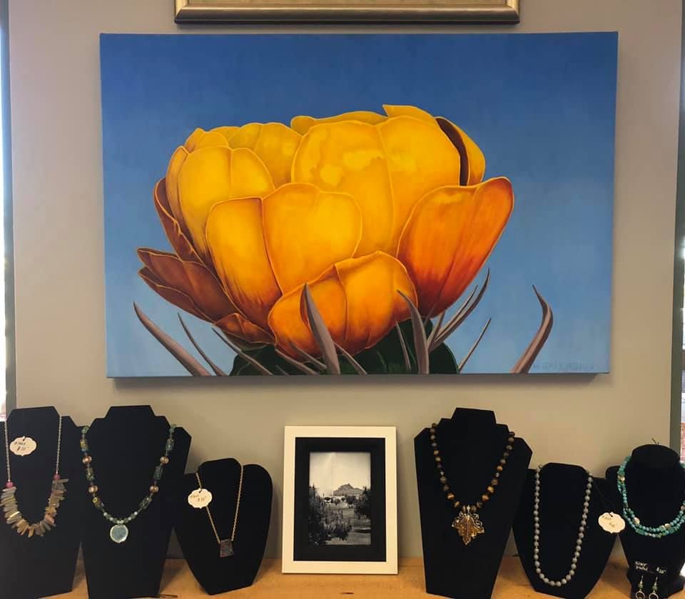 A white truck is parked in a parking lot next to a building.