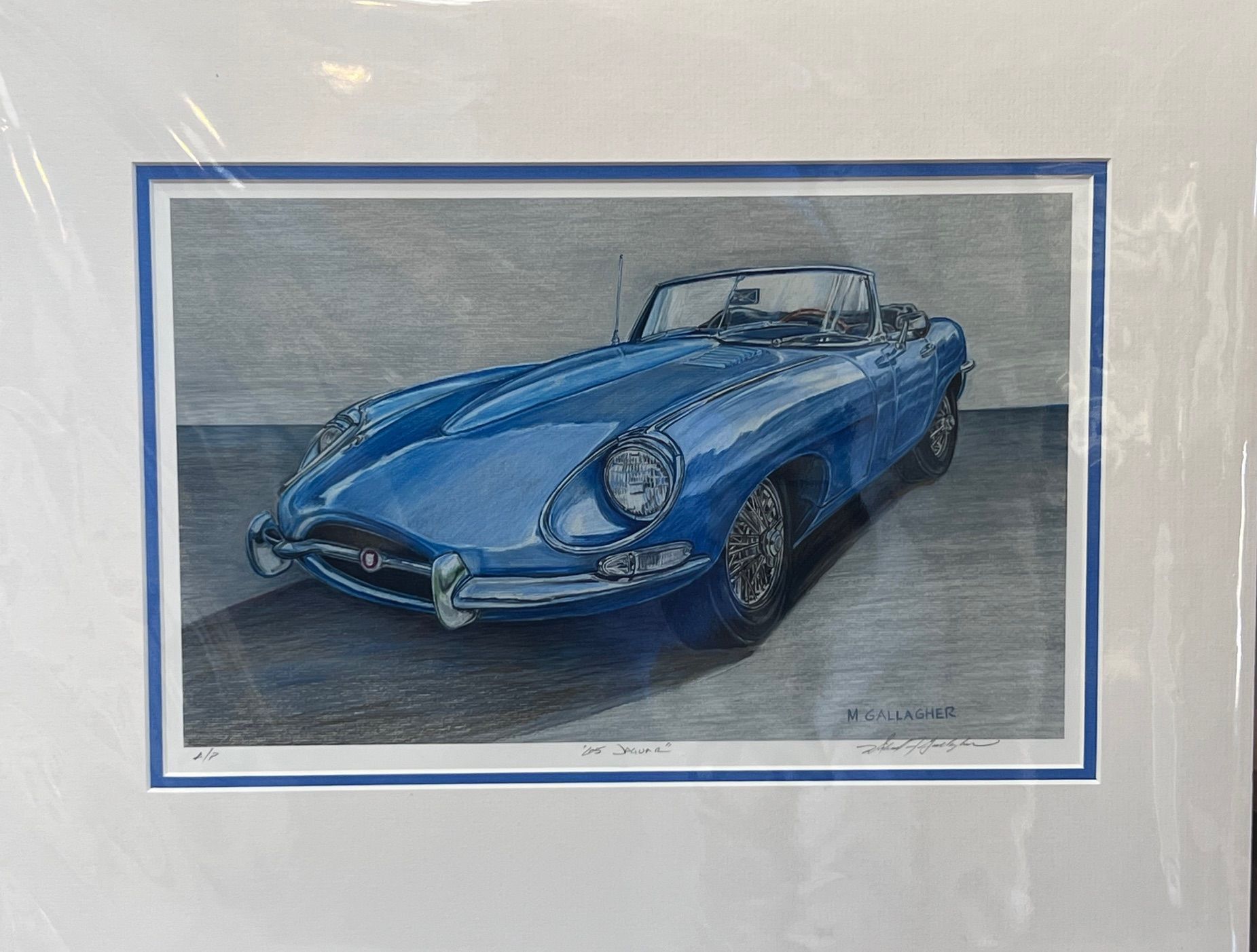 Coastal scene in fog, framed in gold. Dark matting surrounds the muted blue and gray beach.