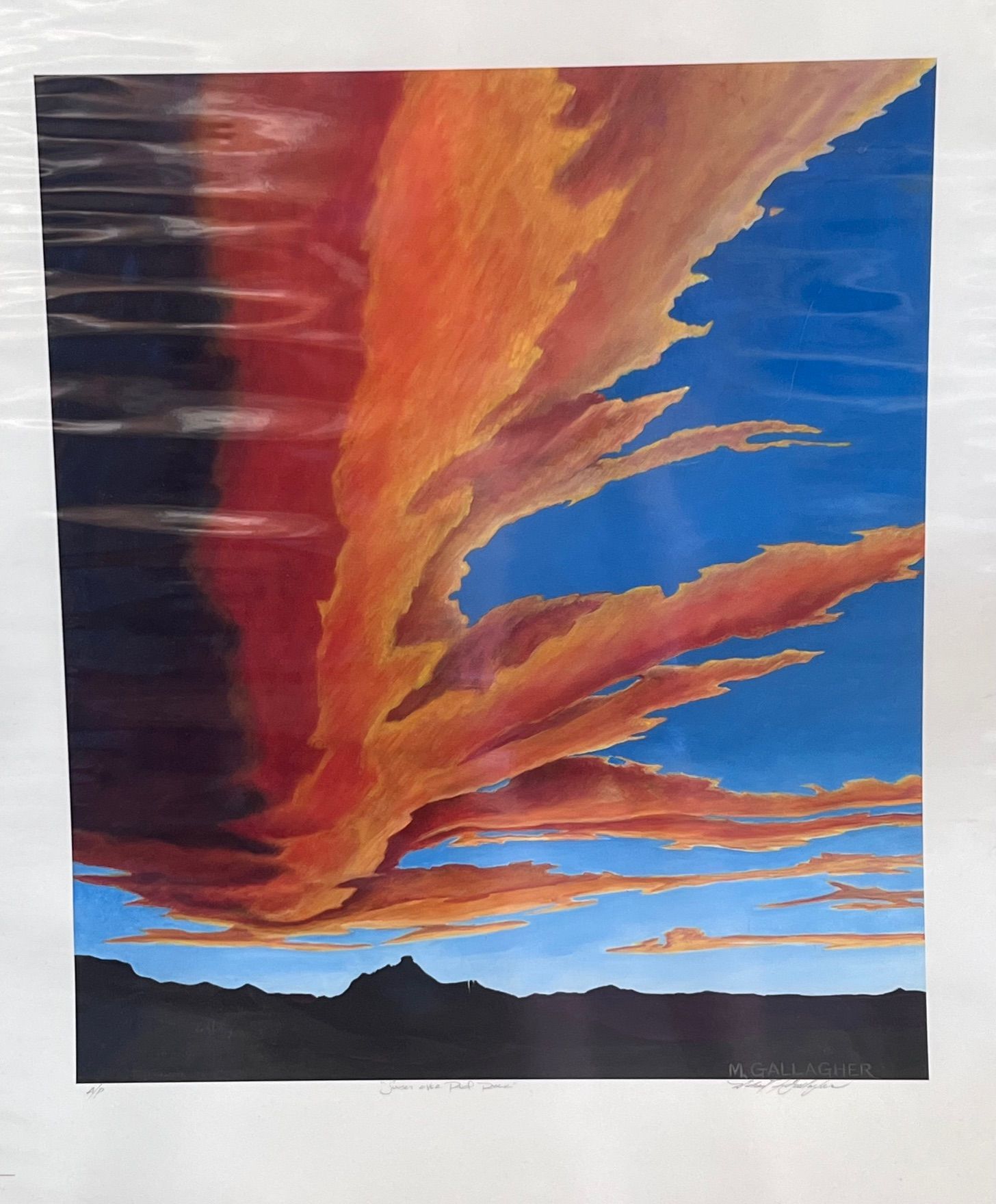 A white truck is parked in a parking lot next to a building.