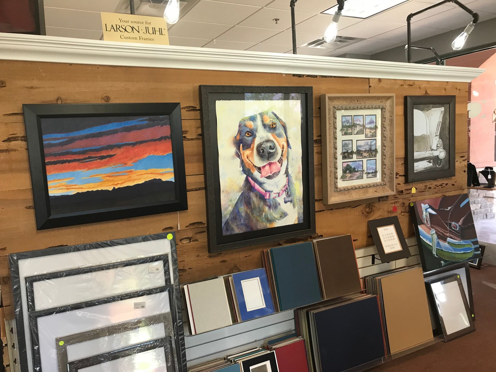 Artwork display: Dog portrait, landscape, framed artwork, mats for sale.