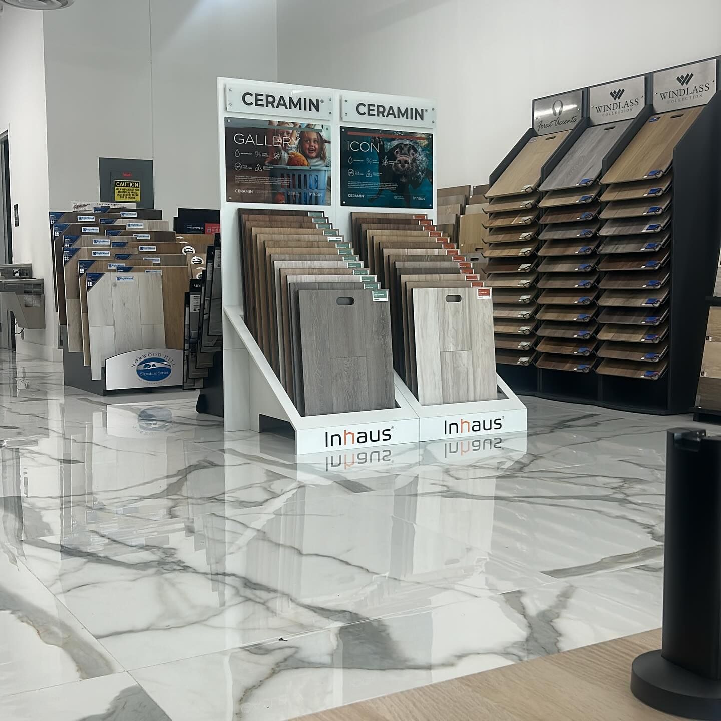 Tile showroom featuring sample displays and a reflective marble floor.