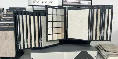 Displays of carpet samples in a store, including a variety of colors and textures.