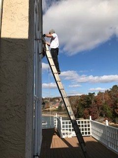 Man On Ladder Installing Glass — Knoxville, TN — Glass Pros Knoxville