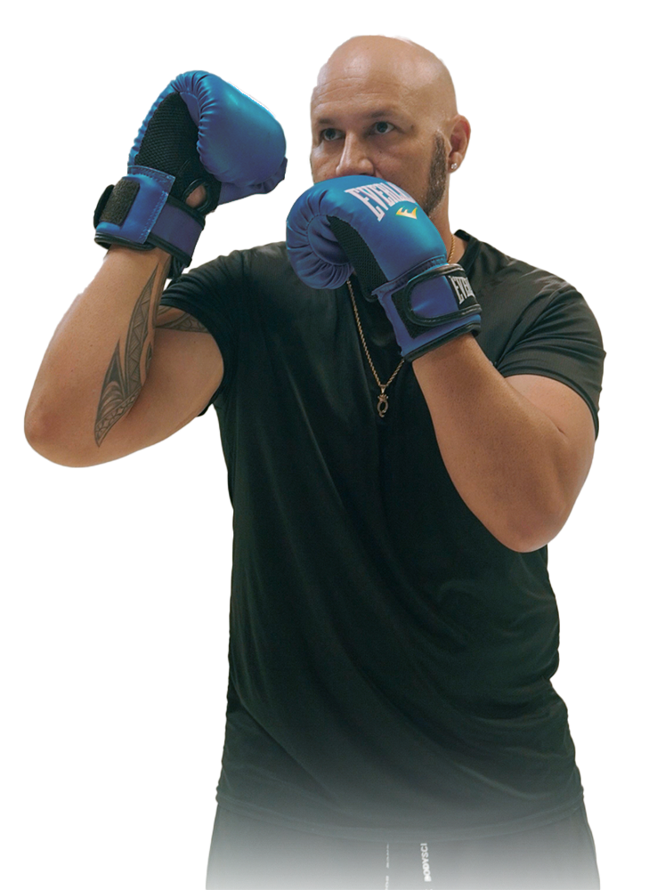 Quintin Wakefield  wearing blue boxing gloves is standing in a boxing stance.