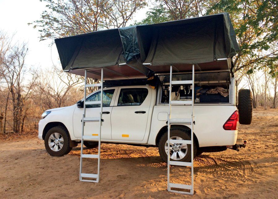 A White Truck With a Tent on Top of It — Murgon Auto Parts & Outdoors in Murgon, QLD