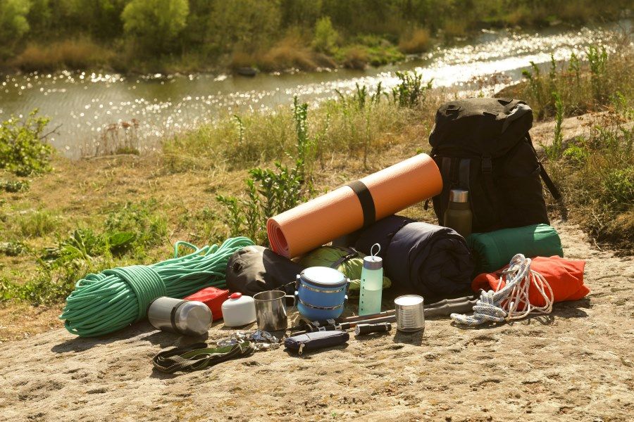 A Pile of Camping Gear is on the Ground Near a River — Murgon Auto Parts & Outdoors in Murgon, QLD