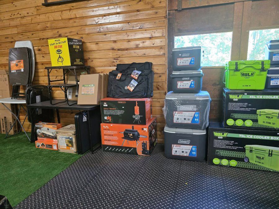 A Bunch of Boxes Are Stacked on Top of Each Other in a Room — Murgon Auto Parts & Outdoors in Murgon, QLD