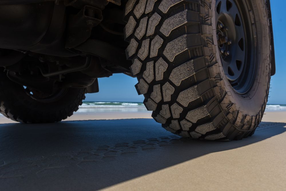A Black Toyota Tacoma is Parked on a Dirt Road — Murgon Auto Parts & Outdoors in Murgon, QLD