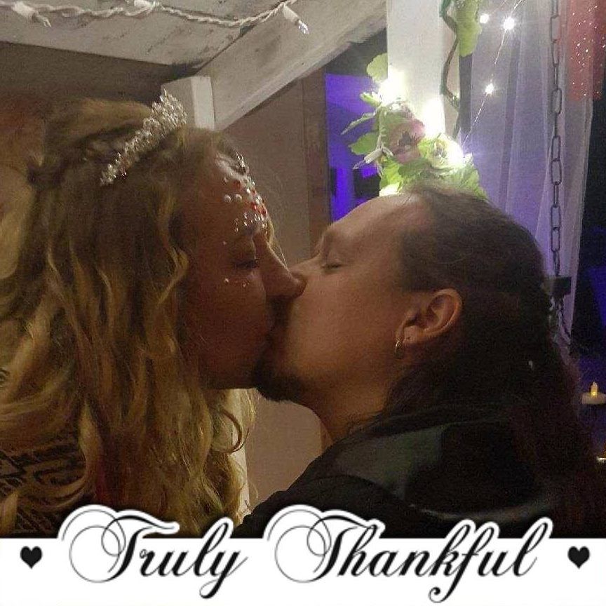 A man and woman kissing with the words truly thankful below them, Dusty Dionne and Belladonna LaVeau.