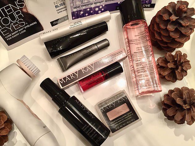 A variety of mary kay makeup products are sitting on a table.