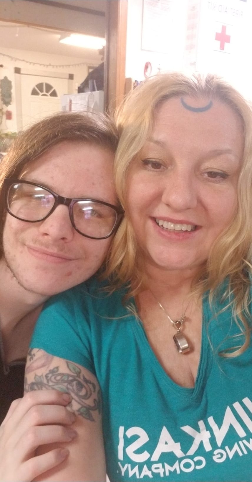 A man and a woman are posing for a picture together . the woman is wearing glasses, Belladonna LaVeau.