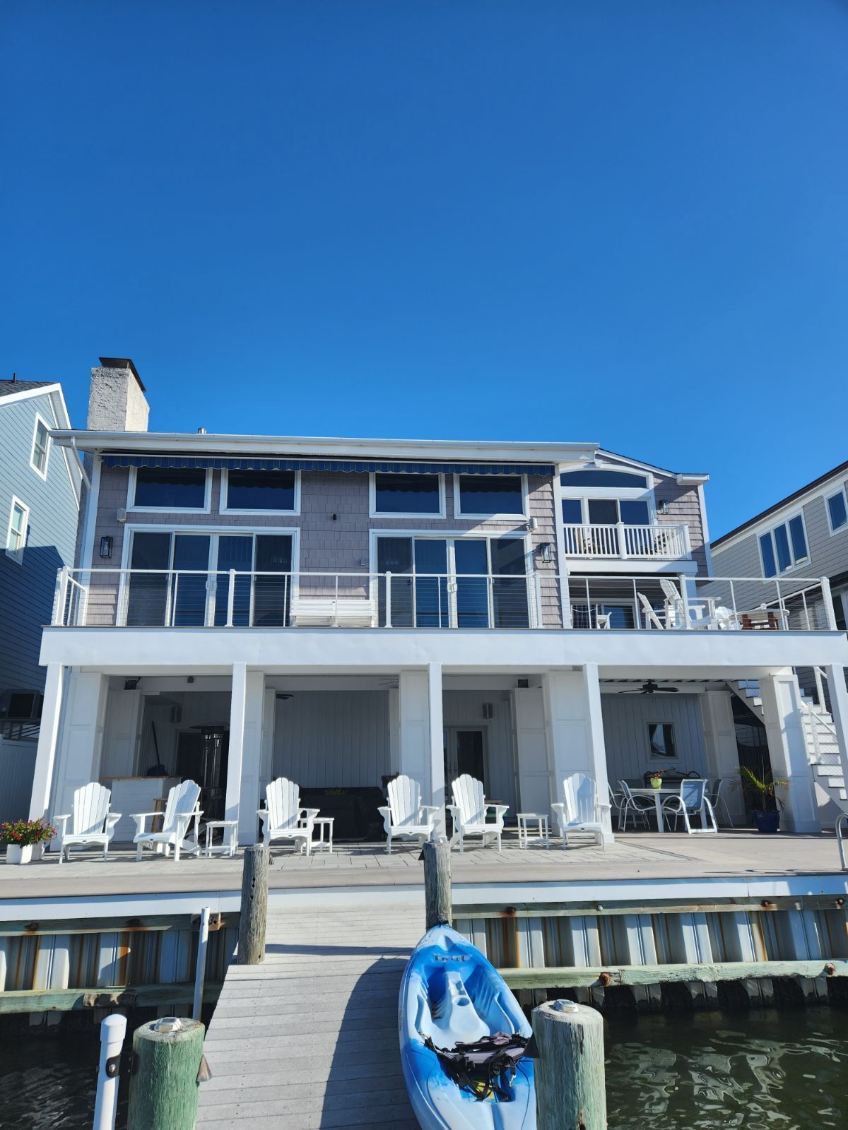A large house with a kayak docked in front of it.