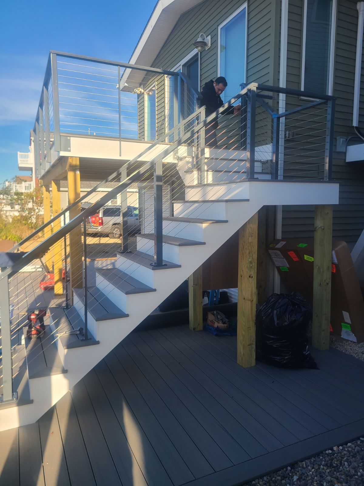 A man is standing on the stairs of a house.