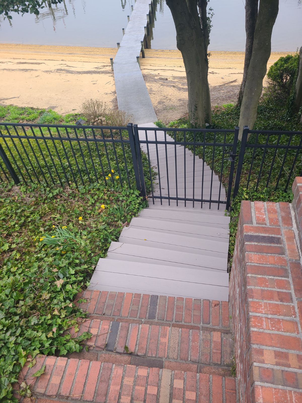 A set of stairs leading up to a dock next to a lake.