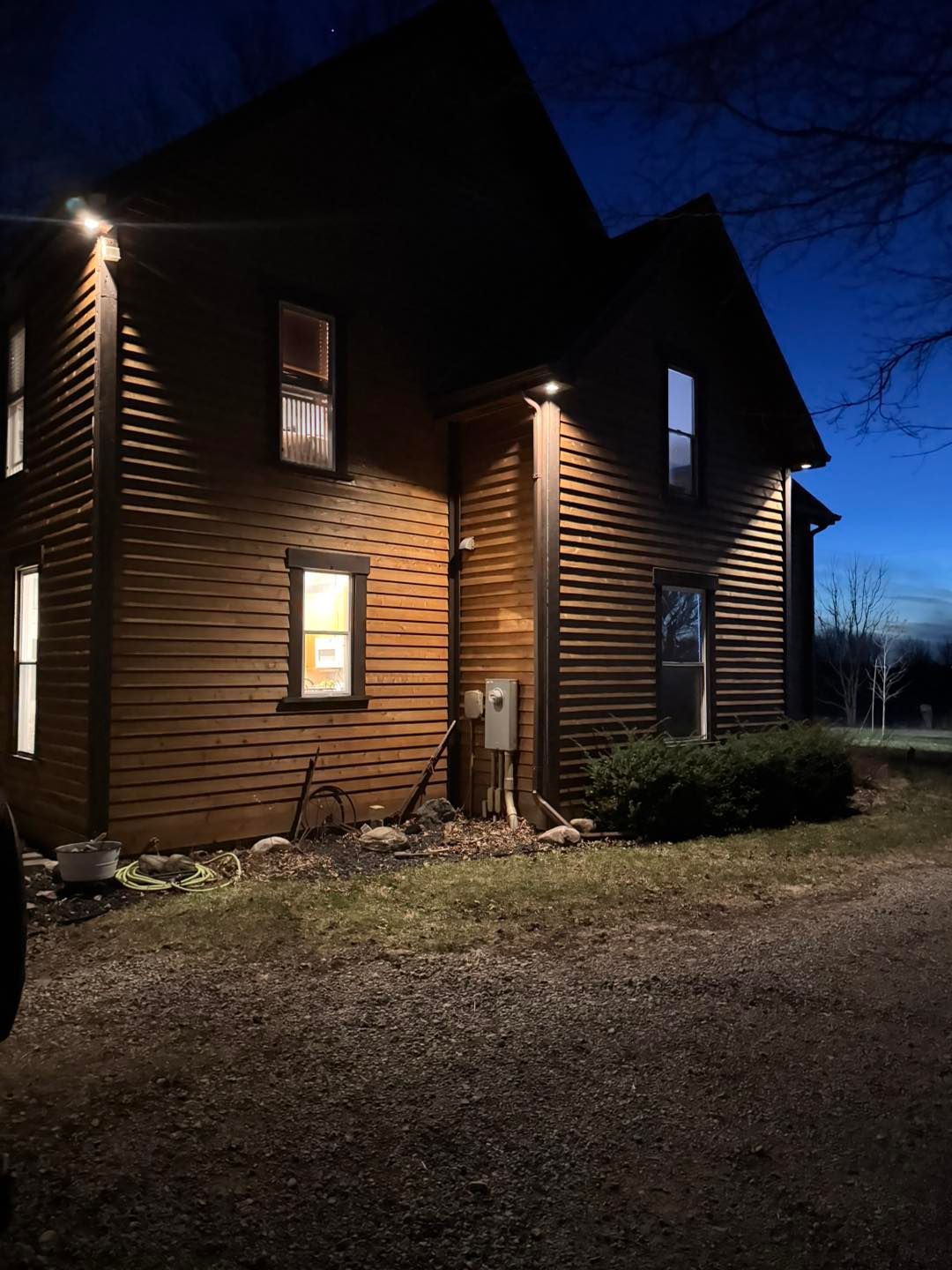 A house with a lot of windows is lit up at night