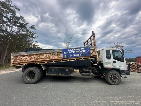 A White Dump Truck is Parked — Lakesway Earthmoving in Charlotte Bay, NSW