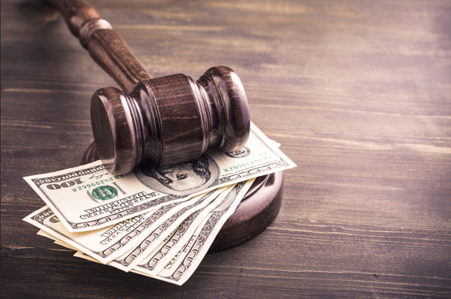 Gavel and some dollars banknotes on wooden table, symbolizing a bankruptcy law attorney Detroit, MI. Gavel and some dollars banknotes on wooden table, symbolizing a bankruptcy law attorney Detroit, MI.