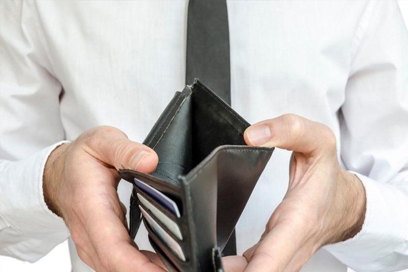 Man Showing Empty Wallet — Livonia, MI — Charles J Schneider PC