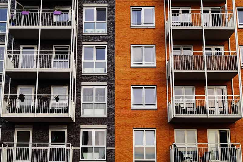 Black And Orange Apartment Building — Livonia, MI — Charles J Schneider PC