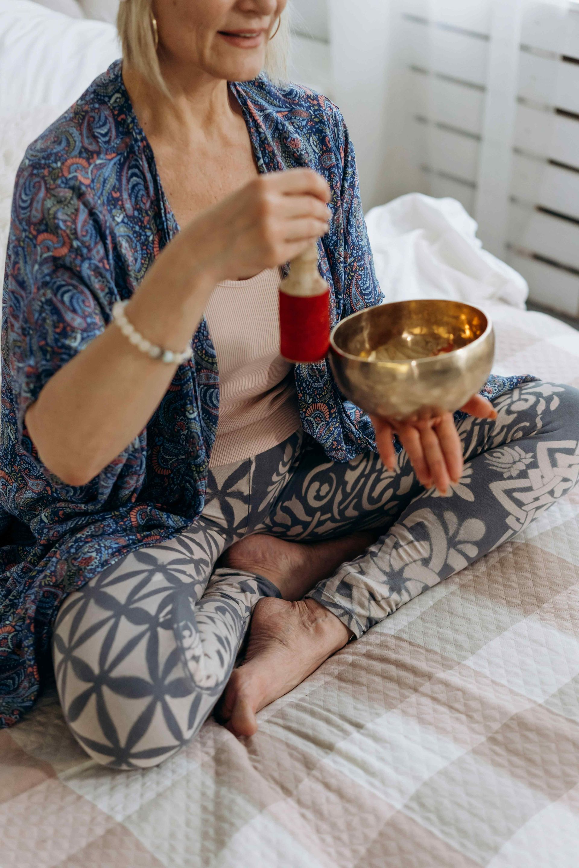 Woman holding a sound therapy bowl and performing vibroacoustic therapy