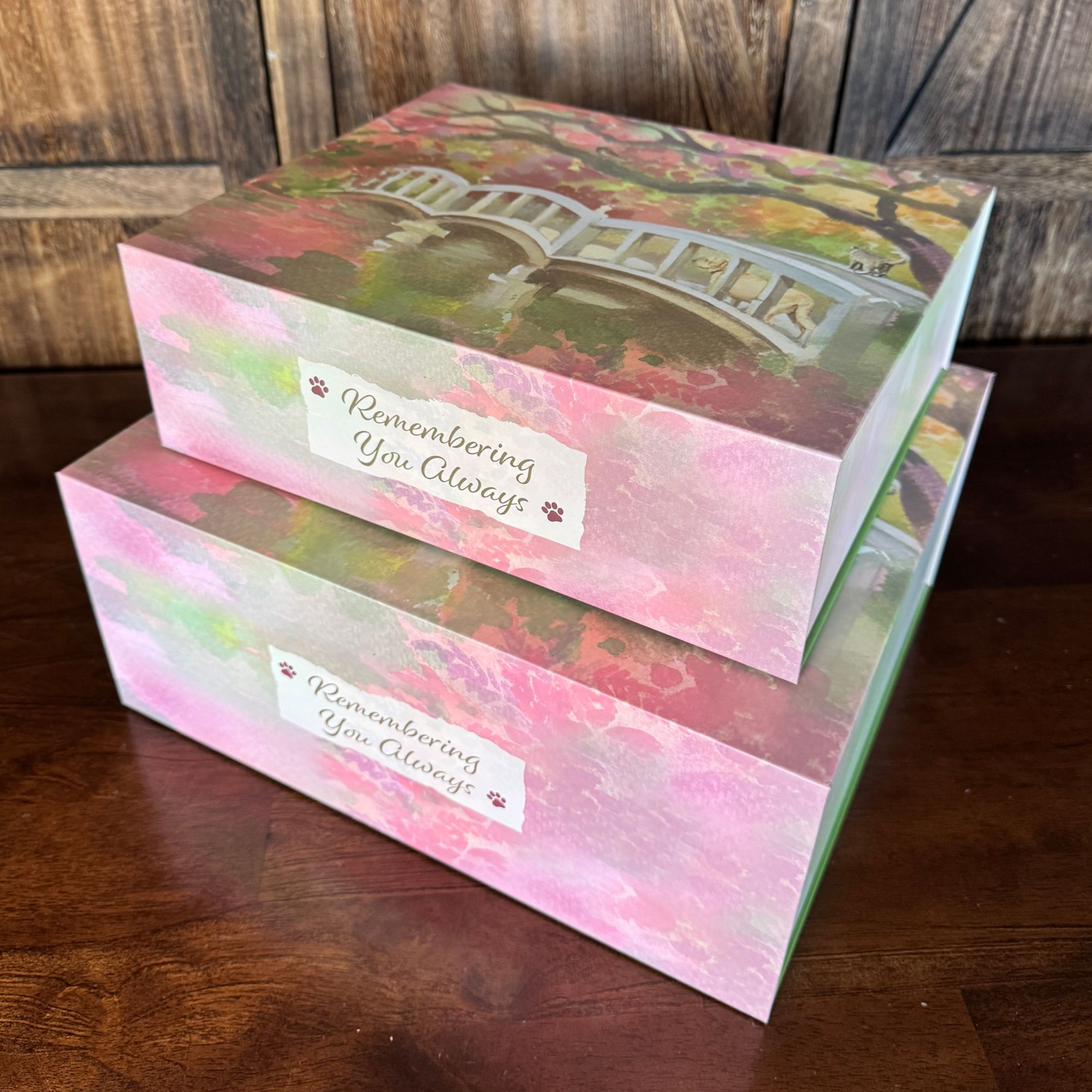 Two decorative boxes, one atop the other, with a painting of a bridge, and text that reads