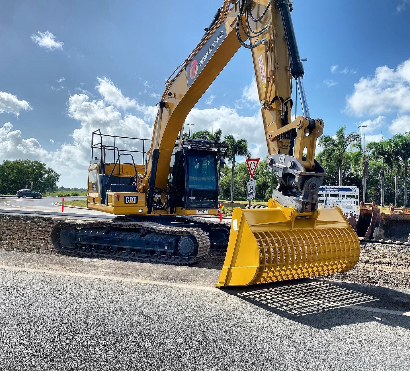 Yellow Excavator With a Grinding Attachment — Terranovus Earthworks & Plant Hire in Tablelands, QLD