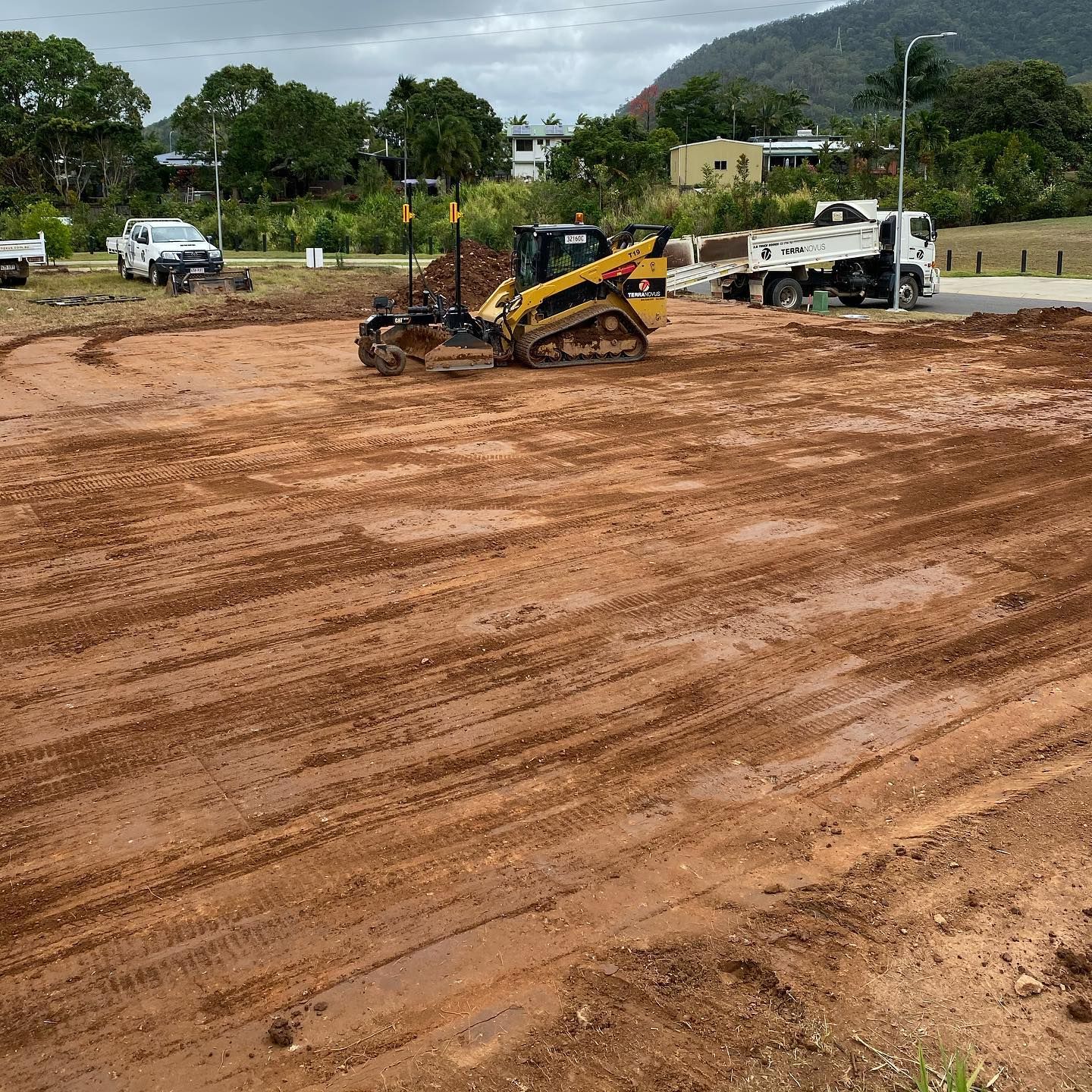Construction Site With a Skid Steer, Dump Truck, and Soil — Terranovus Earthworks & Plant Hire in Cairns City, QLD