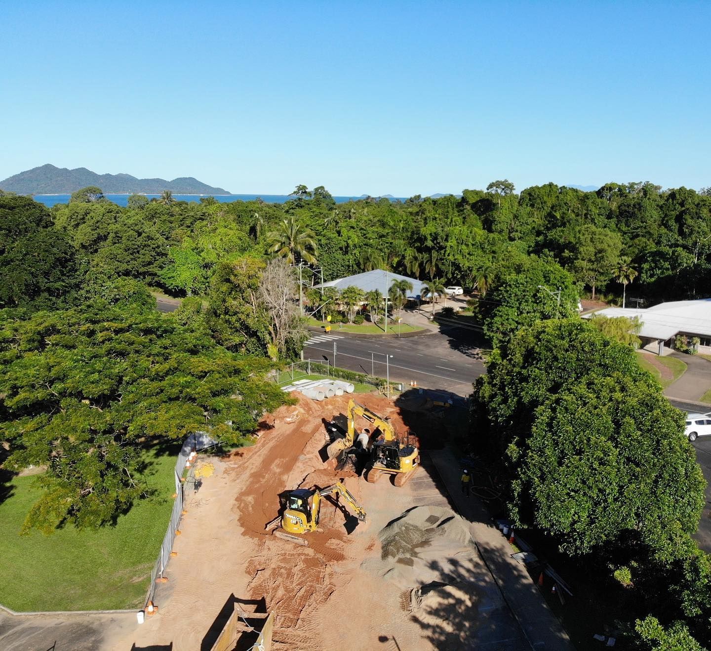 Construction Site With Yellow Excavators on Dirt Pile — Terranovus Earthworks & Plant Hire in Far North, QLD