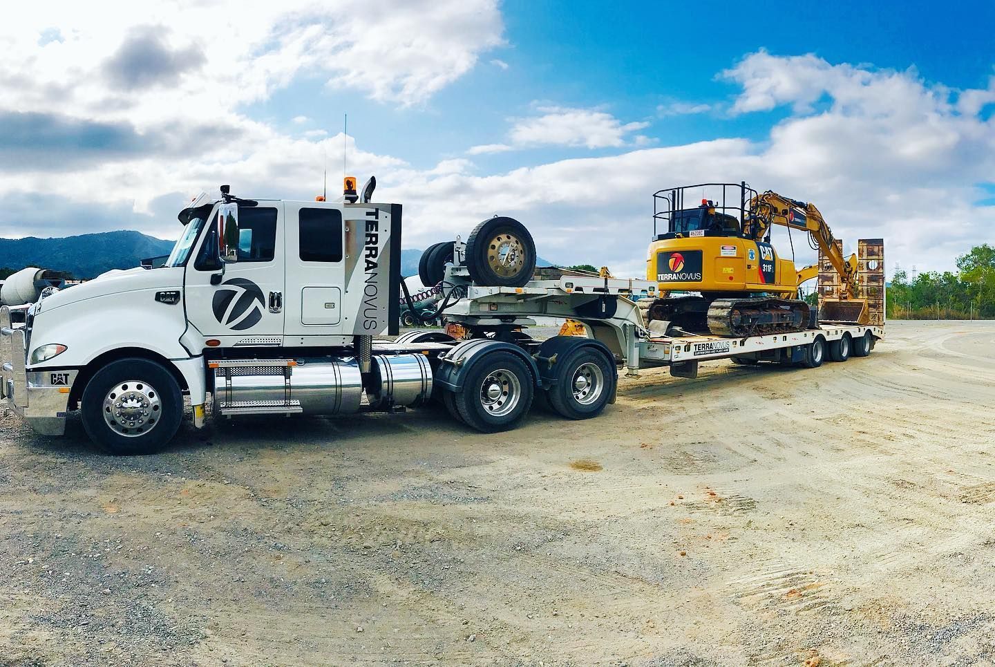 White Semi-truck Hauling a Yellow Excavator — Terranovus Earthworks & Plant Hire in Cairns City, QLD