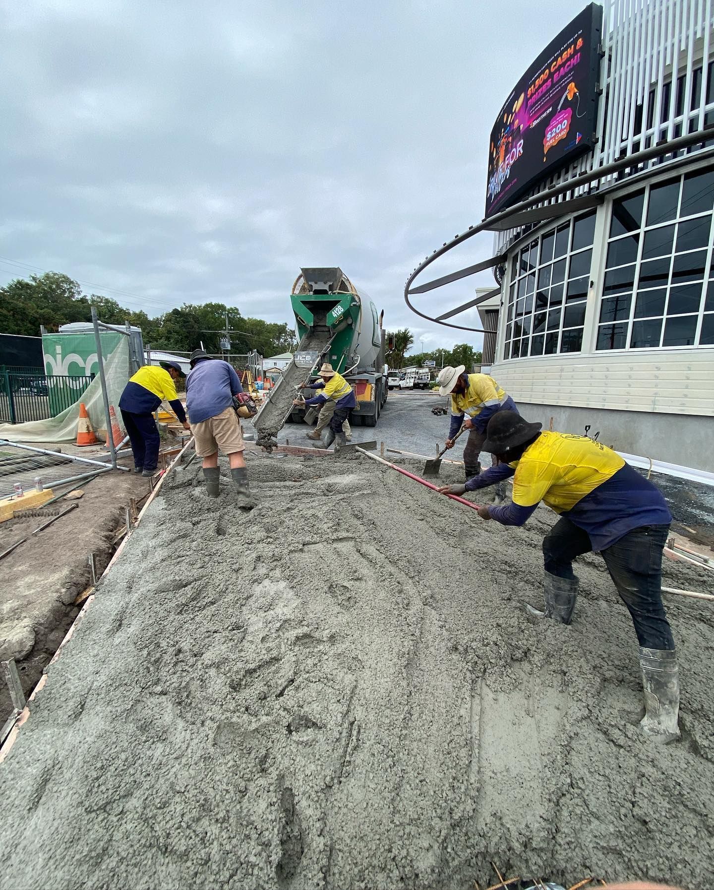 Construction Workers Pouring and Levelling Concrete — Terranovus Earthworks & Plant Hire in Far North, QLD