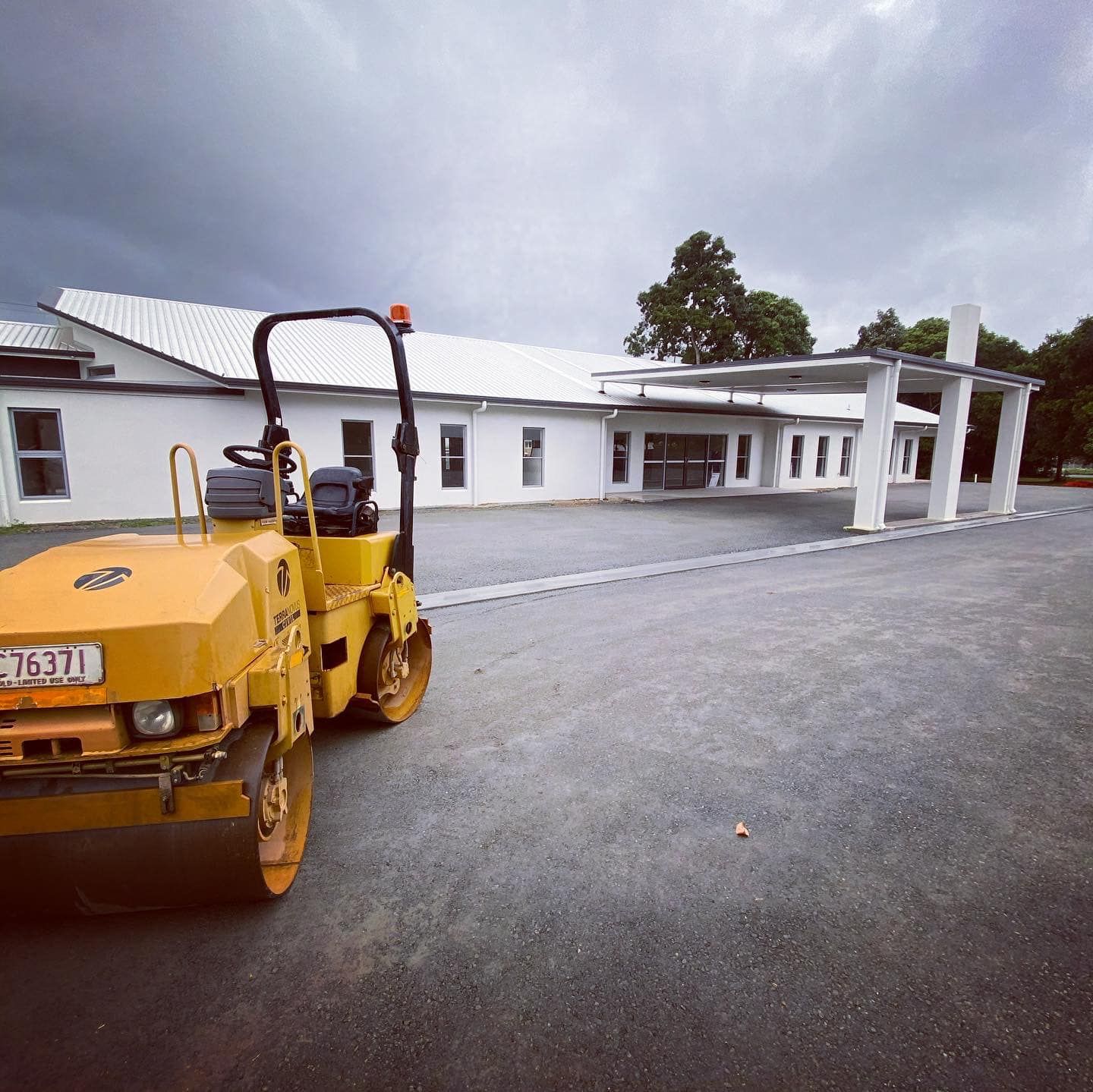 Yellow Road Roller Compacting Asphalt — Terranovus Earthworks & Plant Hire in Cairns City, QLD