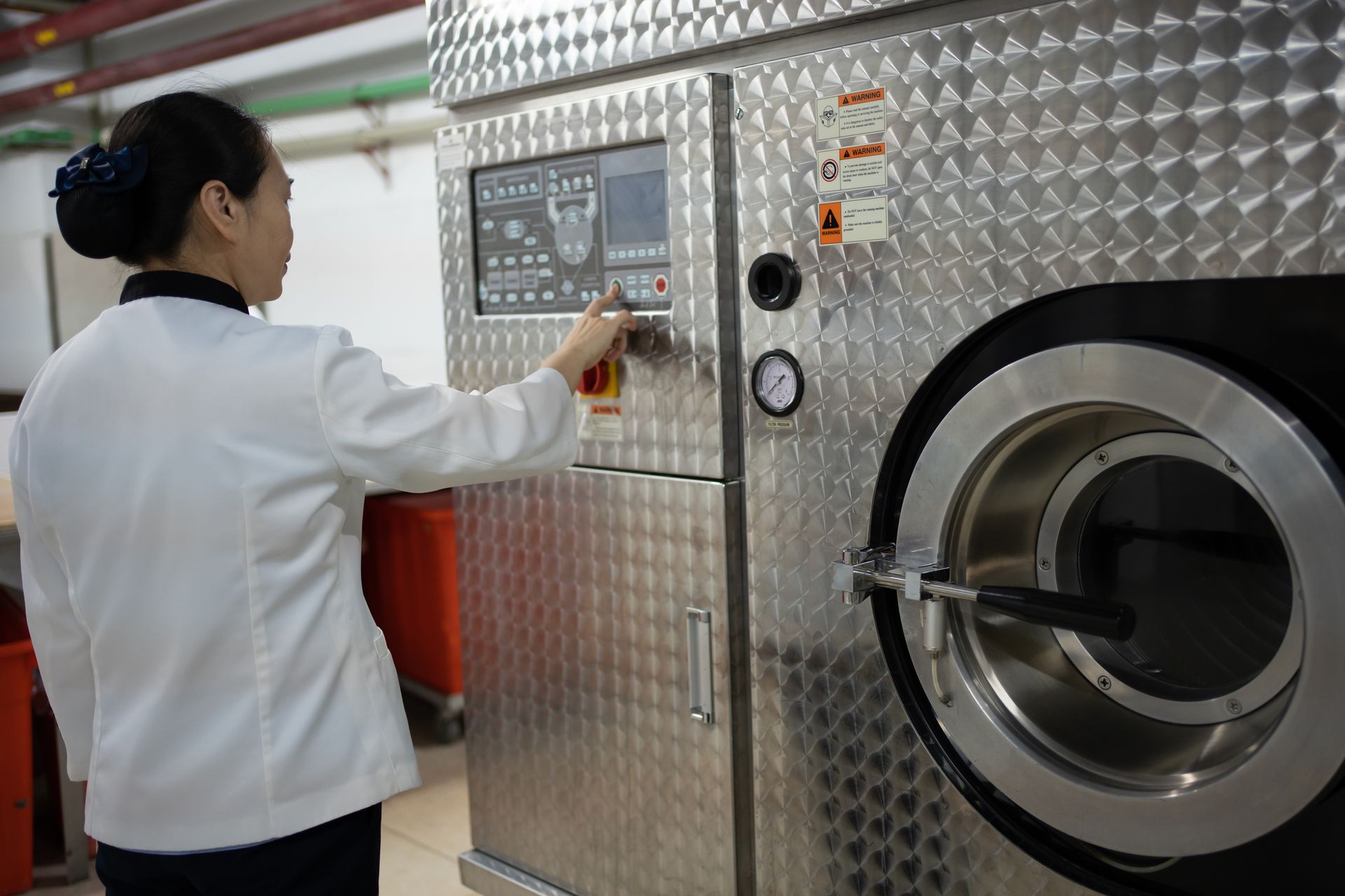 A row of white washing machines in a laundromat
